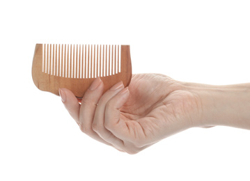 Photo of Woman holding wooden hair comb on white background, closeup