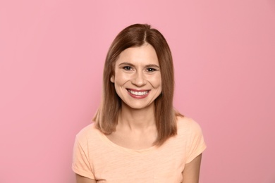 Photo of Smiling woman with perfect teeth on color background