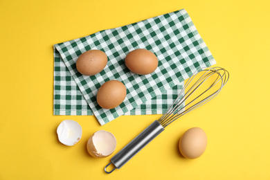 Photo of Flat lay composition with chicken eggs on yellow background