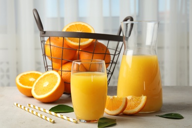 Photo of Composition with orange juice and fresh fruit on table
