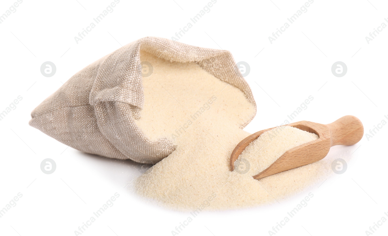 Photo of Bag and scoop with semolina on white background