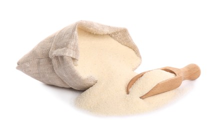 Photo of Bag and scoop with semolina on white background