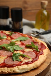Photo of Delicious homemade pita pizza on wooden board, closeup