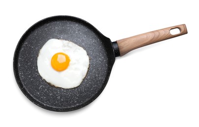 Photo of Frying pan with delicious fried egg isolated on white, top view