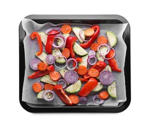 Photo of Baking pan with parchment paper and raw vegetables isolated on white, top view