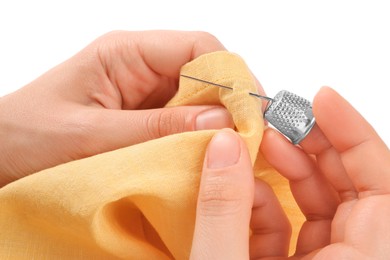 Photo of Woman sewing on yellow fabric with thimble and needle against white background, closeup