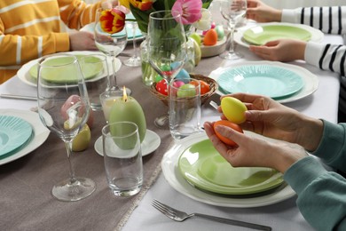 Photo of Festive table setting. Women celebrating Easter at home, closeup