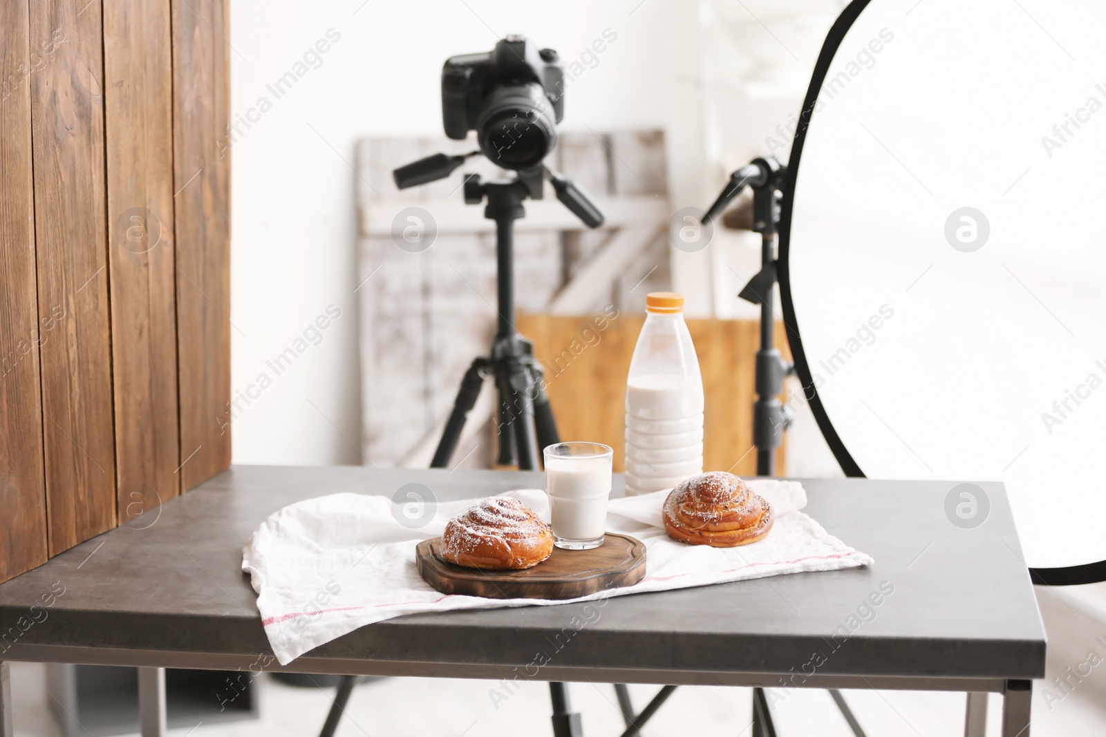 Photo of Professional camera on tripod and food composition in photo studio