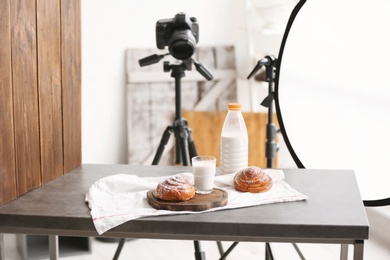 Photo of Professional camera on tripod and food composition in photo studio