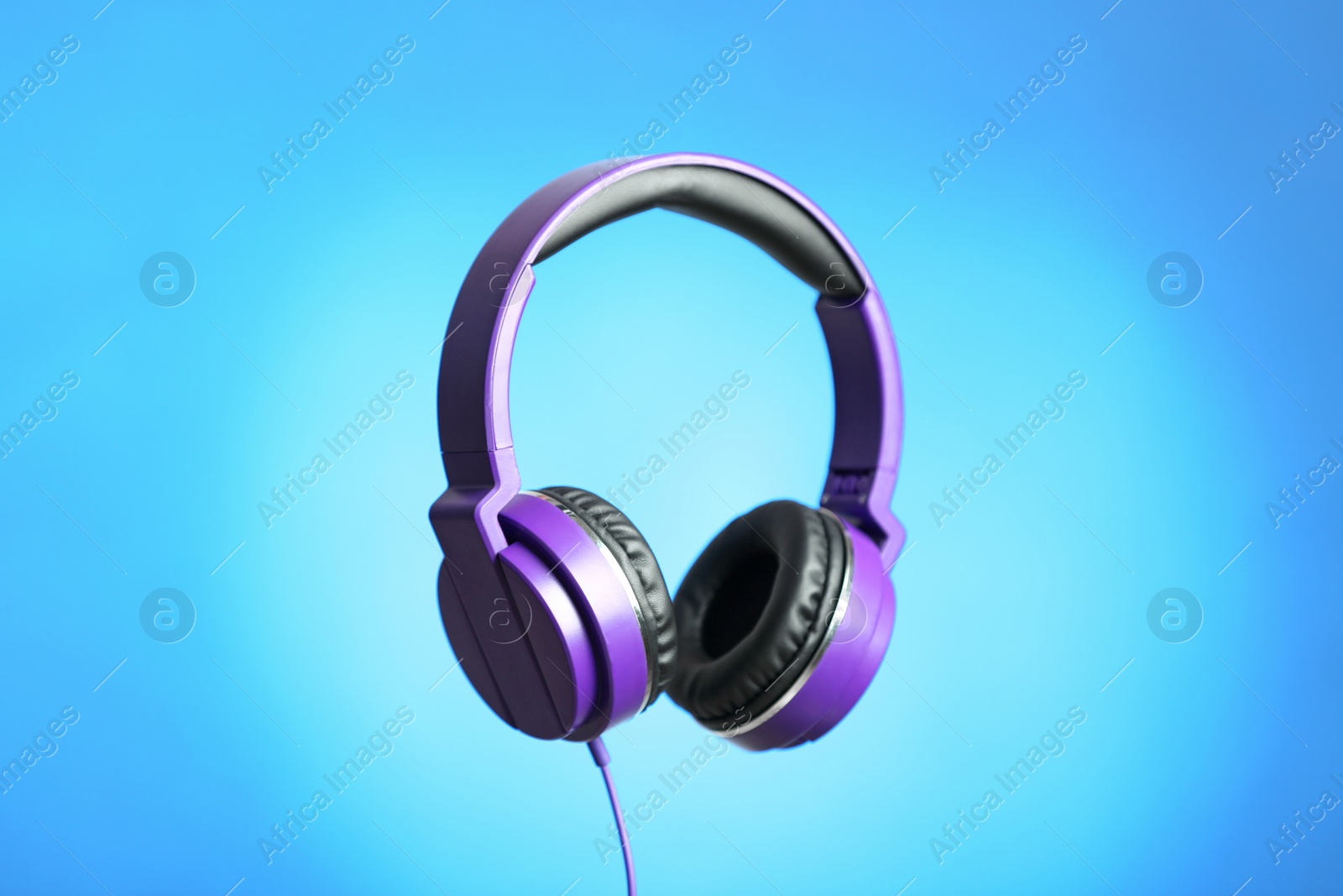 Photo of Stylish headphones with pads on color background