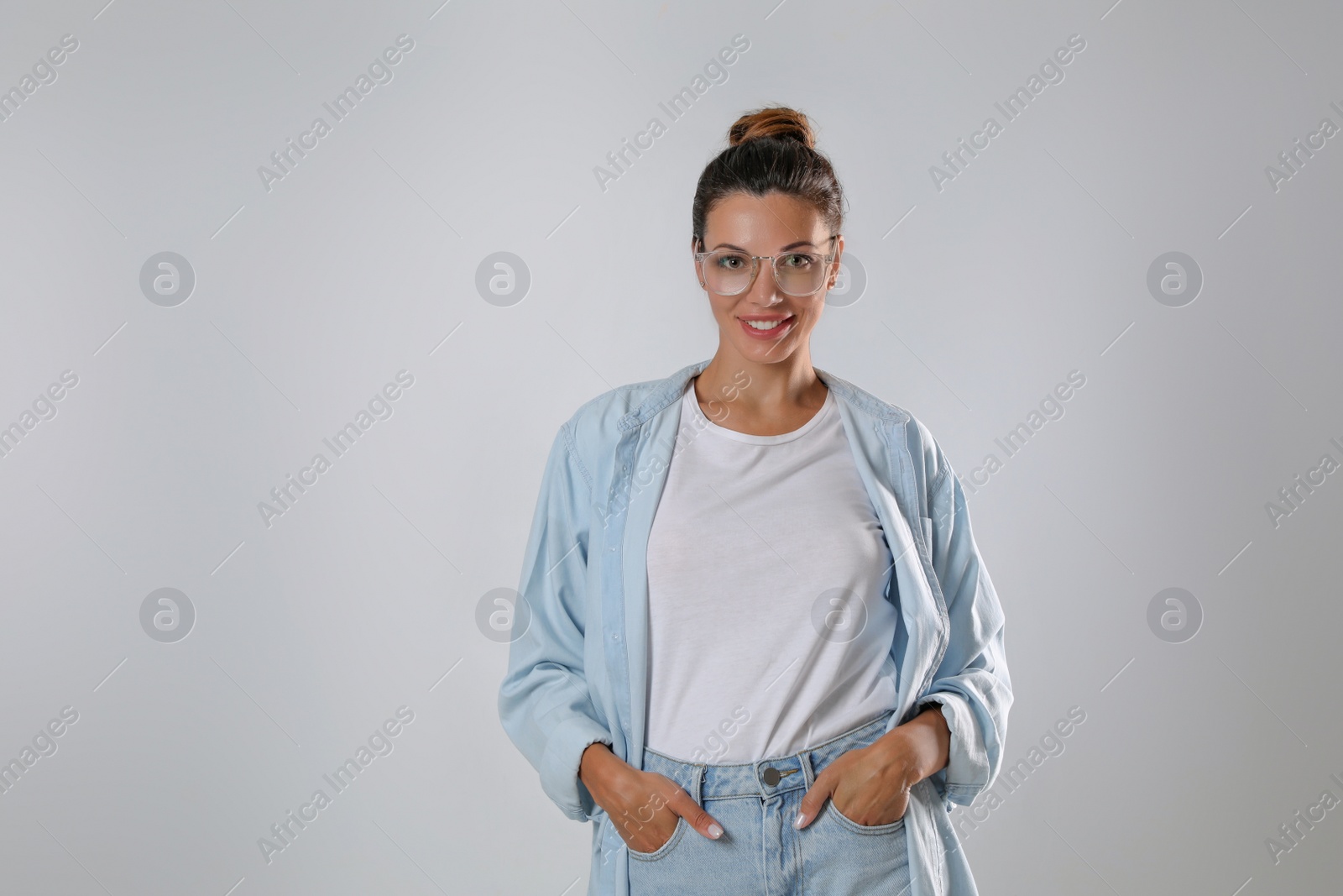 Photo of Beautiful woman in eyeglasses on white background, space for text