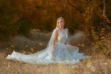 Photo of Beautiful girl wearing fairy dress in autumn forest