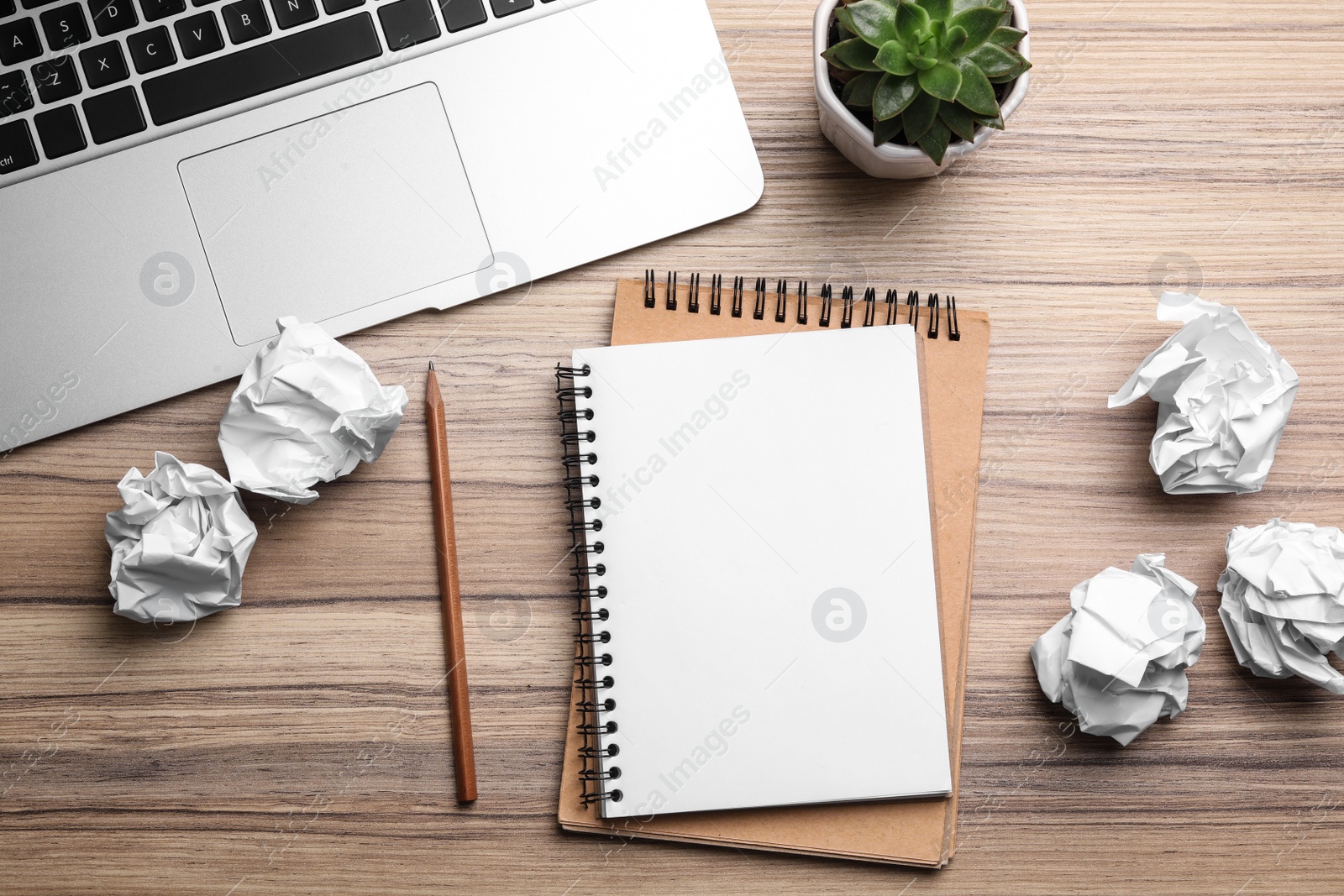 Photo of Flat lay composition with notebook and crumpled paper on wooden table. Space for text