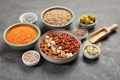 Photo of Different products high in natural fats on grey table