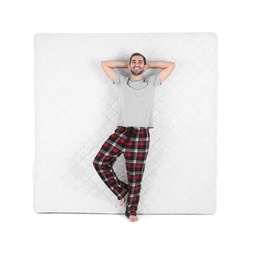 Young man with comfortable mattress isolated on white