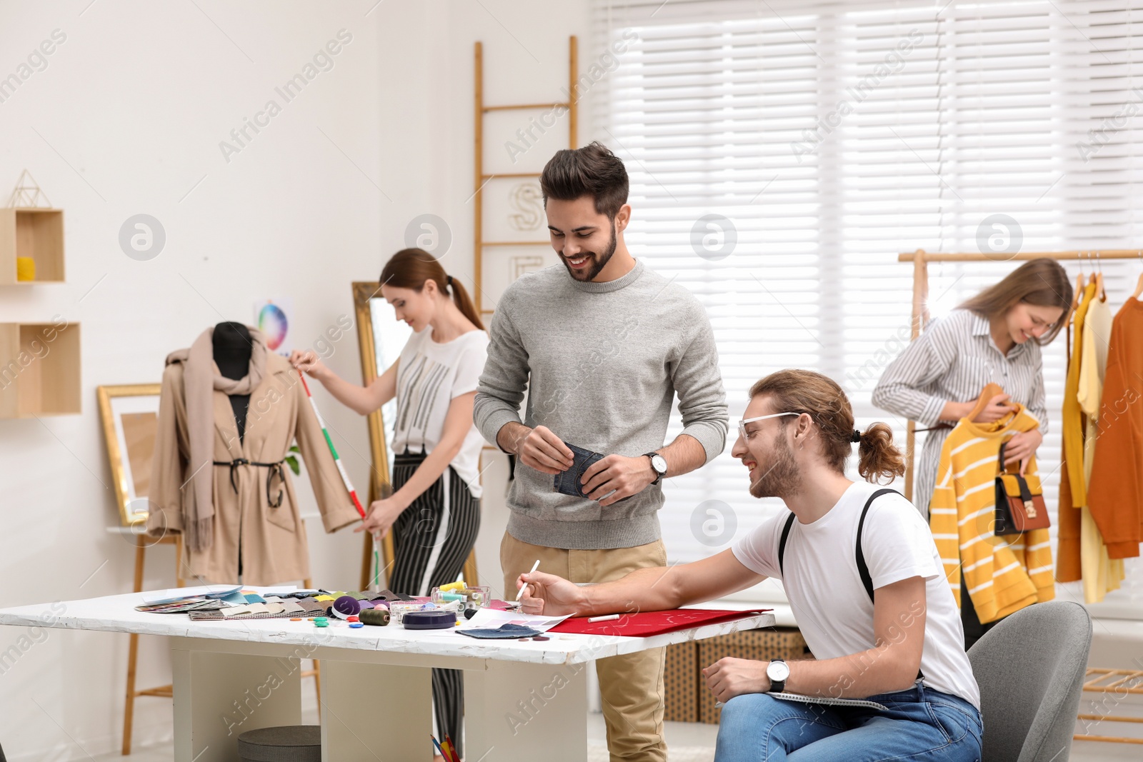 Photo of Fashion designers creating new clothes in studio