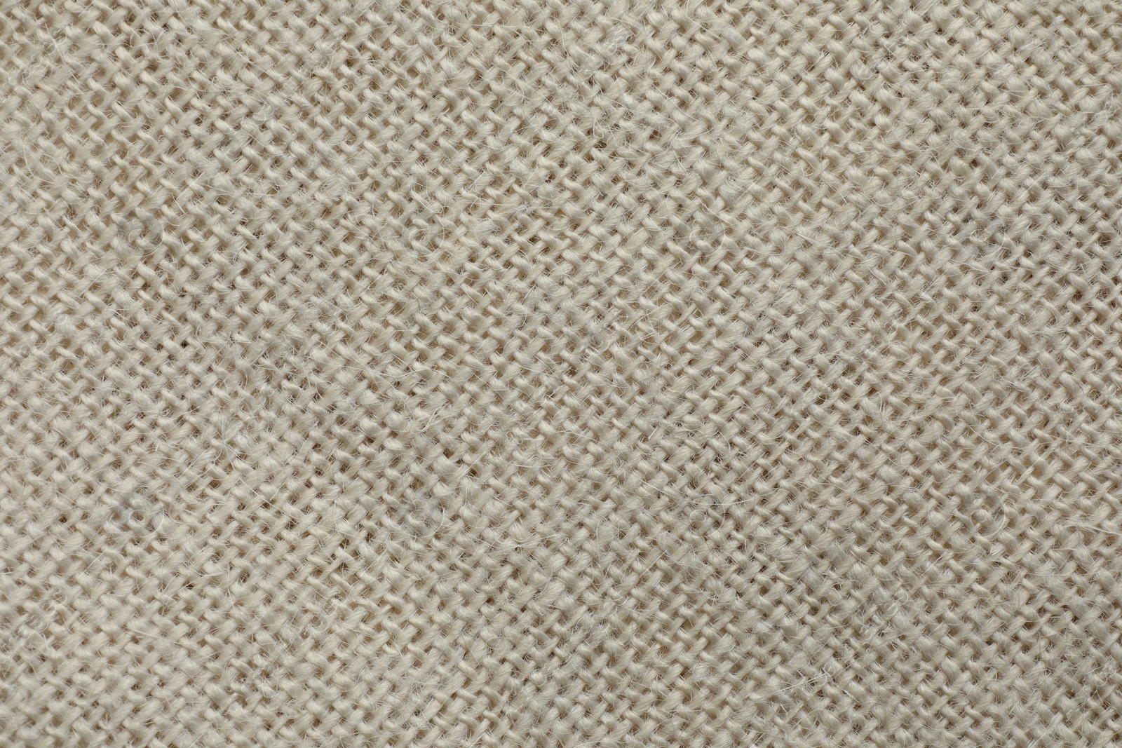 Photo of Texture of beige fabric as background, top view