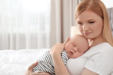 Photo of Mother with her sleeping baby in bedroom