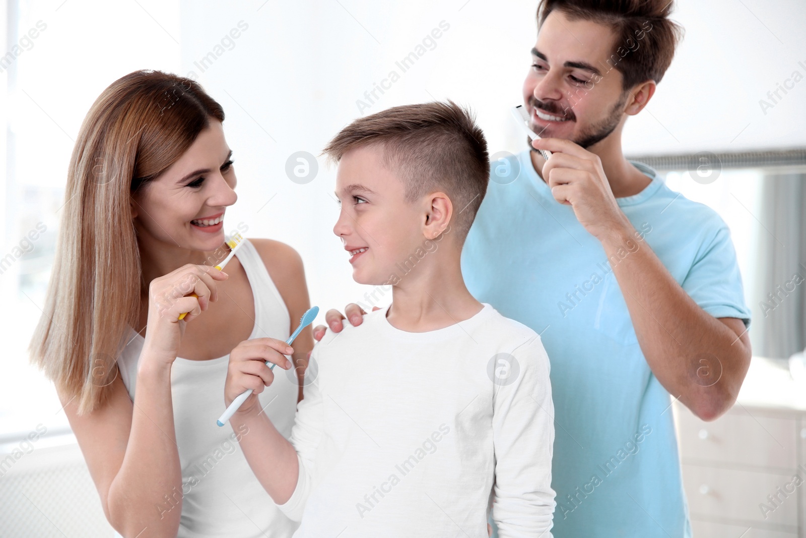 Photo of Happy family with toothbrushes in bathroom. Personal hygiene