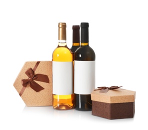 Photo of Bottles of wine and gift boxes on white background