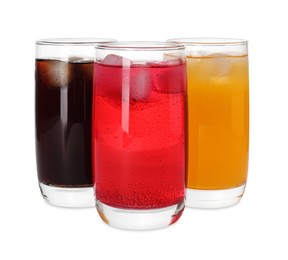 Glasses of different refreshing soda water with ice cubes on white background