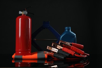 Set of car safety equipment on black background