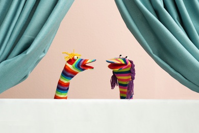 Creative puppet show on white stage indoors