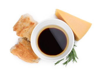 Photo of Bowl of balsamic vinegar with oil, bread, parmesan cheese and rosemary on white background, top view