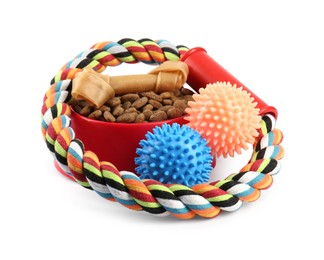 Pet dry food in bowl, treats and toys on white background. Shop assortment