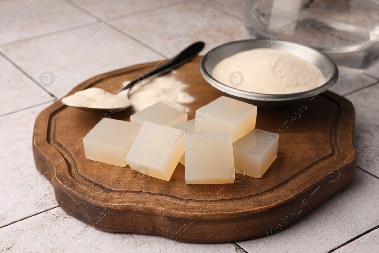 Photo of Agar-agar jelly cubes and powder on tiled surface