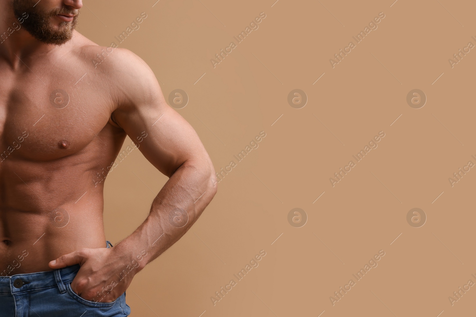 Photo of Muscular man on beige background, closeup and space for text. Sexy body