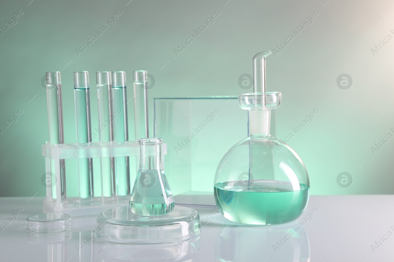 Photo of Laboratory analysis. Different glassware on table against color background