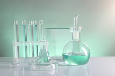 Laboratory analysis. Different glassware on table against color background