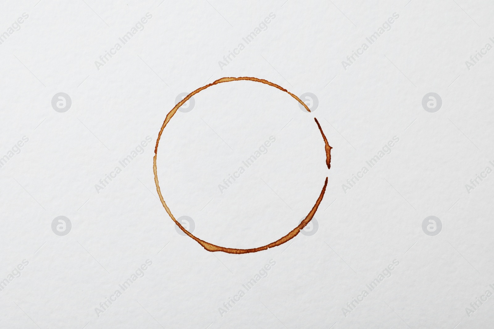 Photo of Dried coffee cup stain on white background, top view