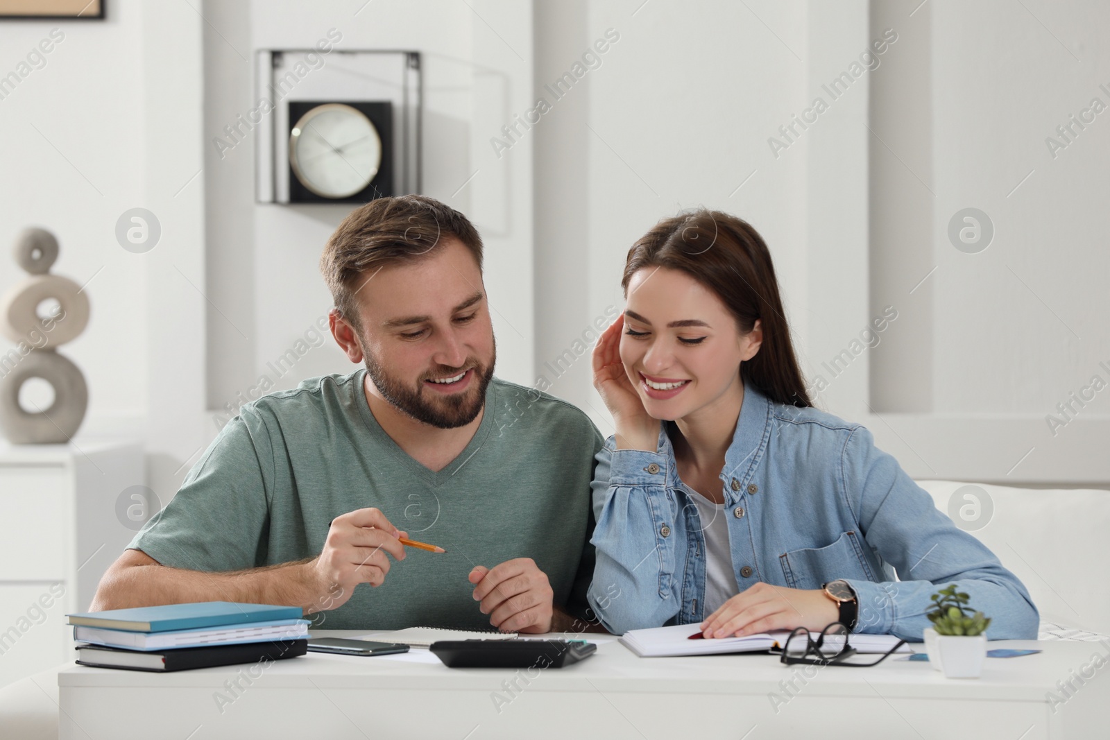 Photo of Young couple discussing family budget at home