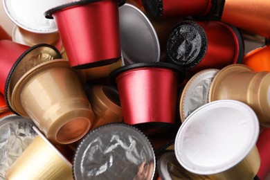 Many coffee capsules as background, closeup view