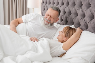 Photo of Mature couple together in bed at home