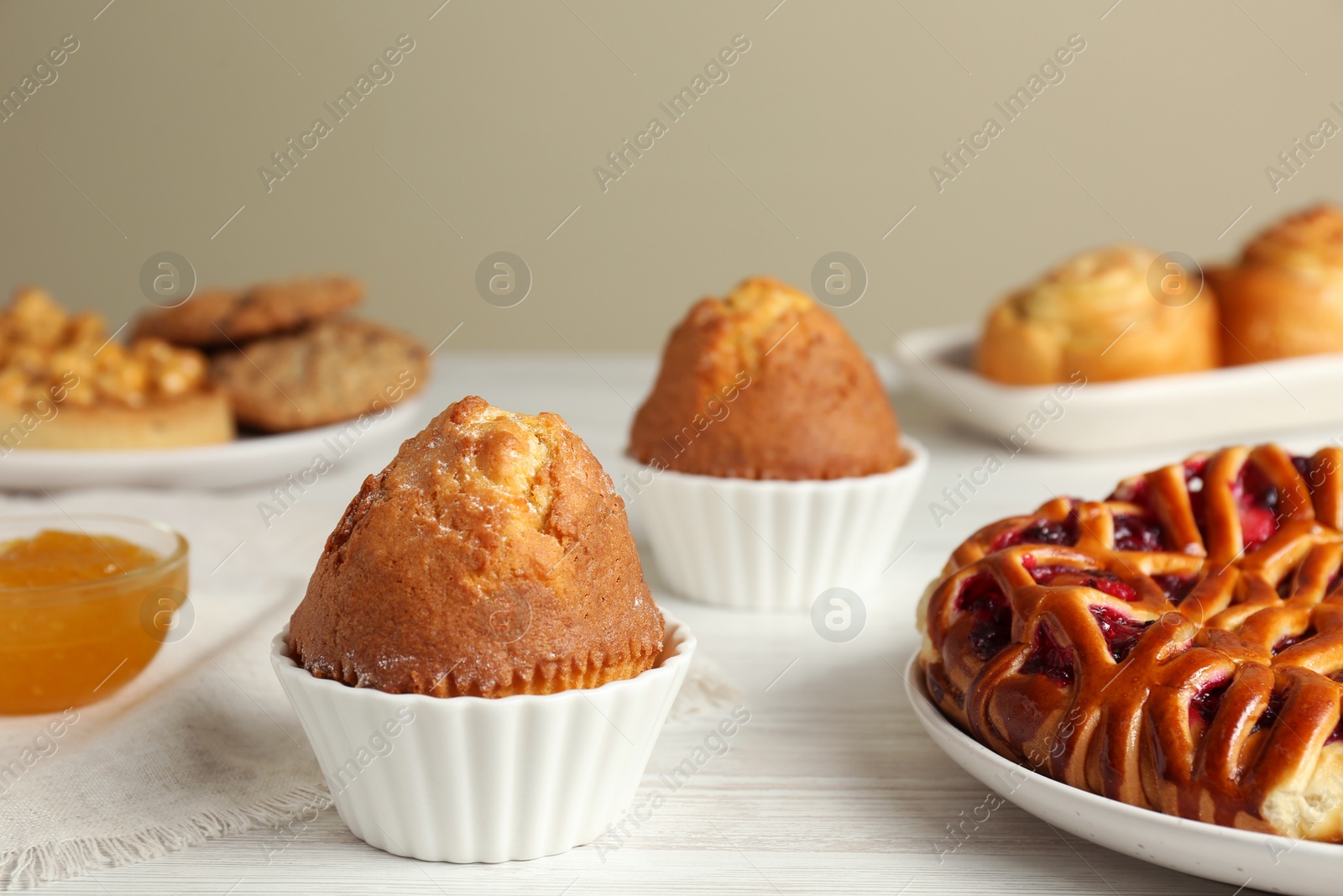 Photo of Delicious fresh pastry on white wooden table