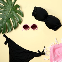 Flat lay composition with stylish bikini on color background. Space for text