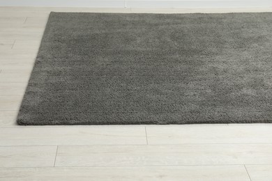 Photo of Soft grey carpet on white laminated floor indoors