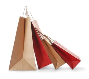 Photo of Empty paper shopping bags on white background