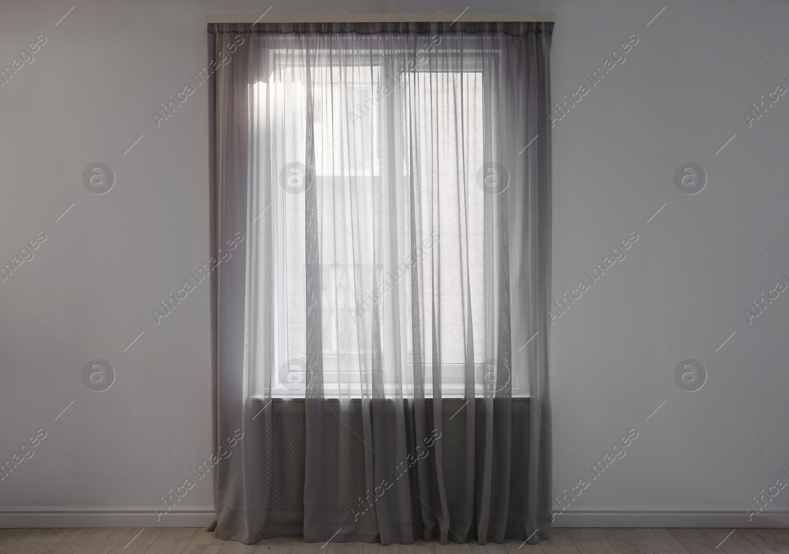 Photo of Window with beautiful curtains in empty room