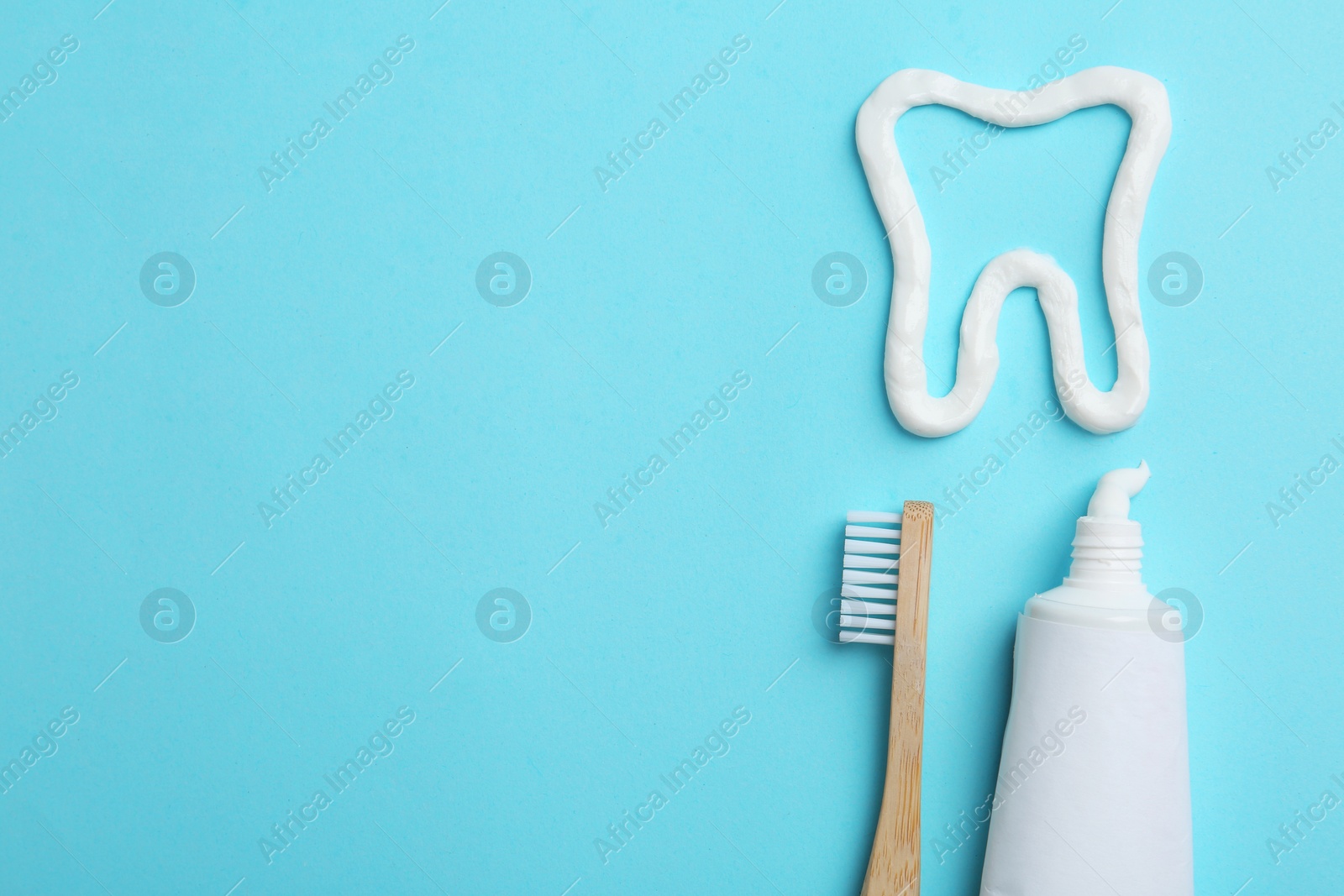 Photo of Tooth made of paste, tube, brush and space for text on color background, flat lay