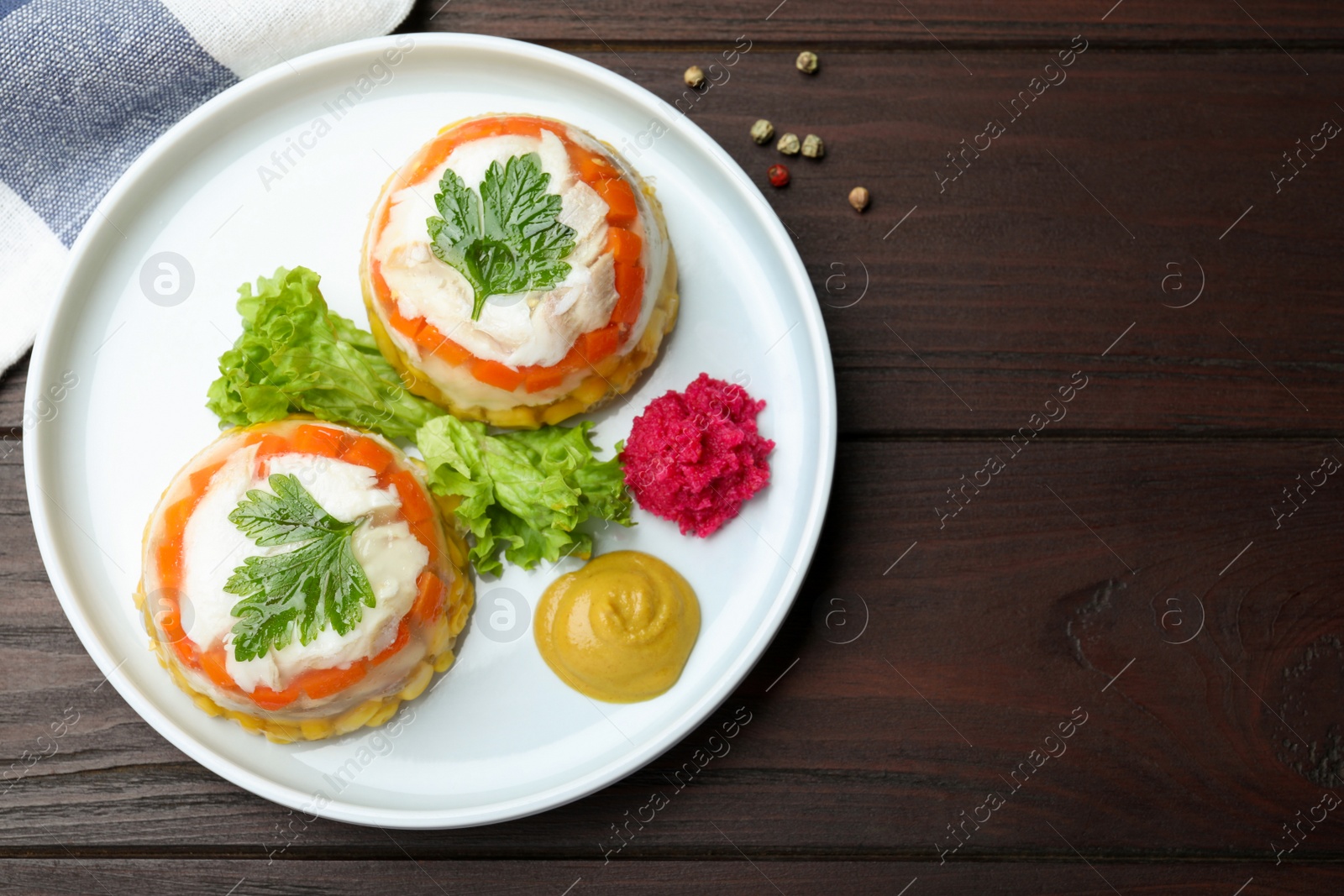 Photo of Delicious fish aspic served on wooden table, flat lay