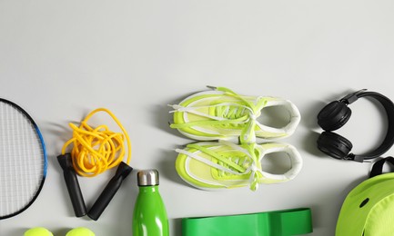 Photo of Different sports equipment on light grey background, flat lay