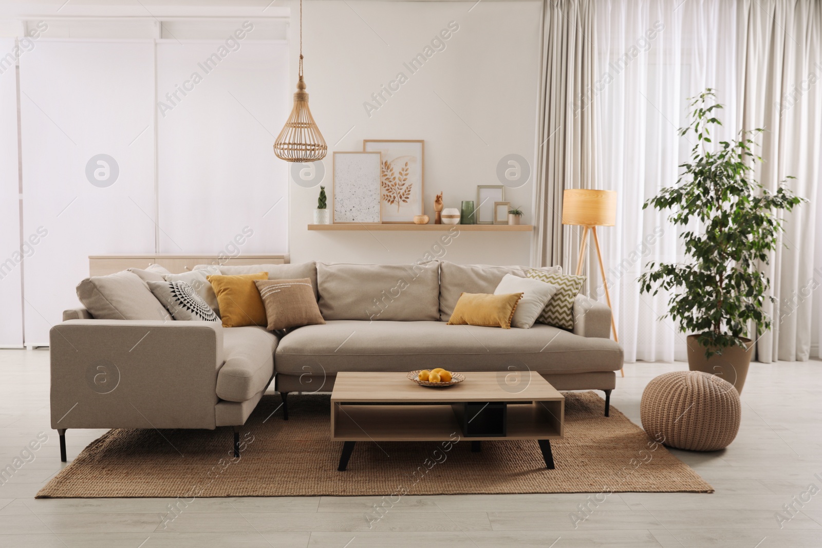 Photo of Stylish living room interior with comfortable grey sofa and coffee table