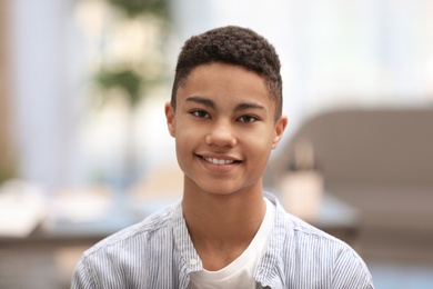 Portrait of African-American teenage boy at home