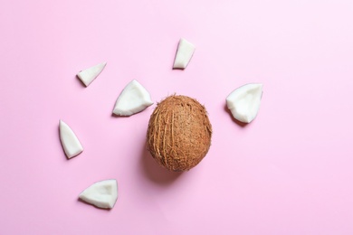 Whole coconut with pieces on color background