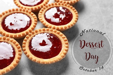 Image of National Dessert Day, October 14. Tasty tartlets with jam on light grey table