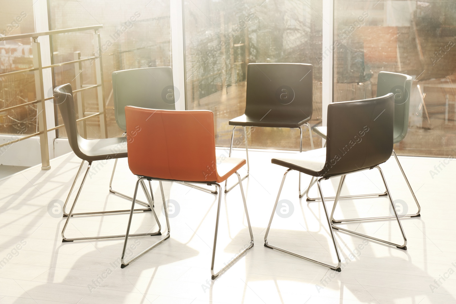 Photo of Chairs prepared for group therapy session in office. Meeting room interior